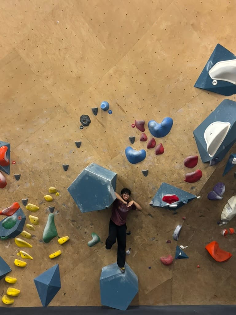 Erik climbing on an indoor bouldering wall.